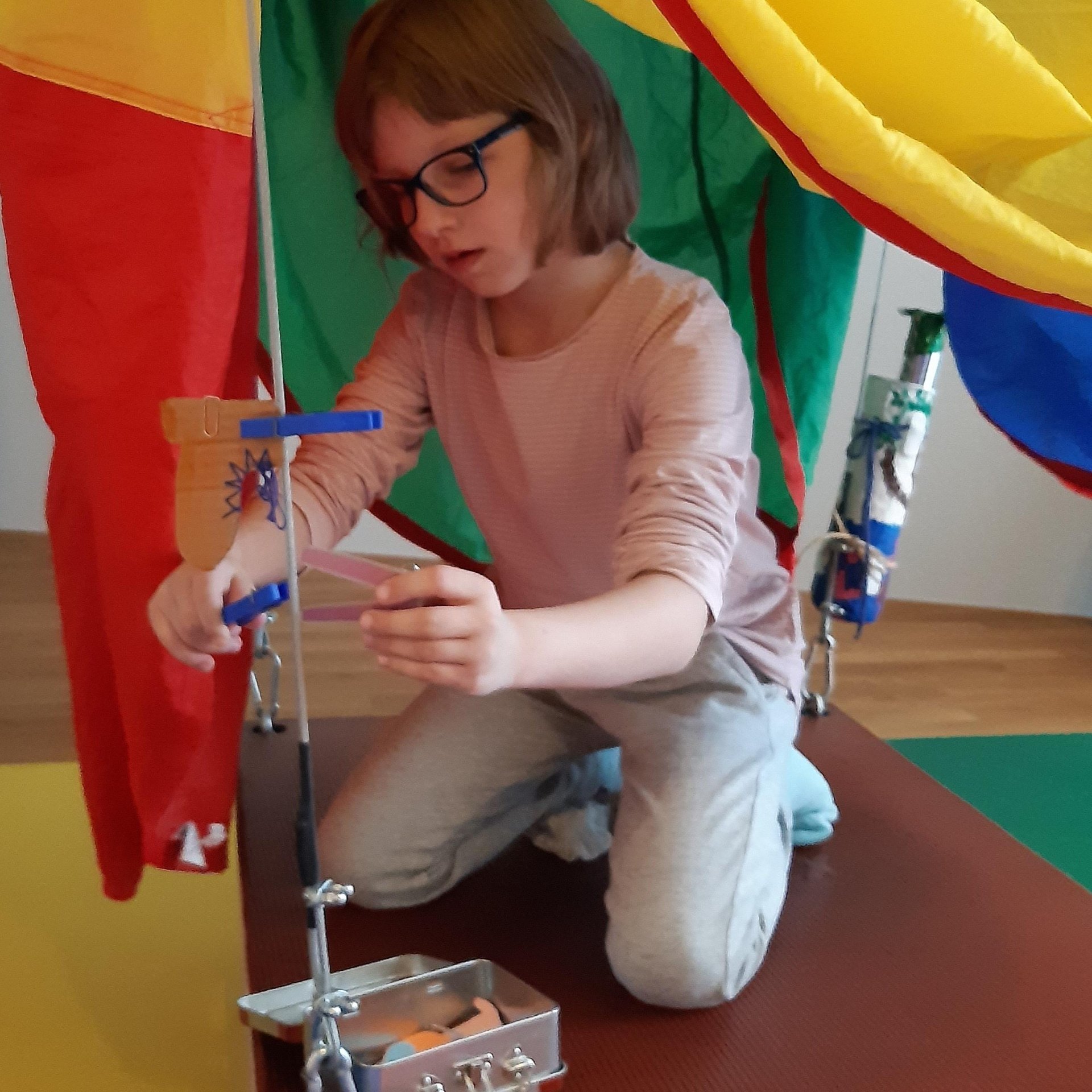 Kind arbeitet konzentriert mit feinmotorischem Material